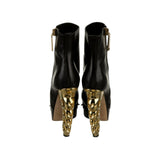 Runway brass knuckle bootie heel