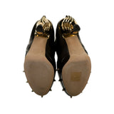 Runway brass knuckle bootie heel